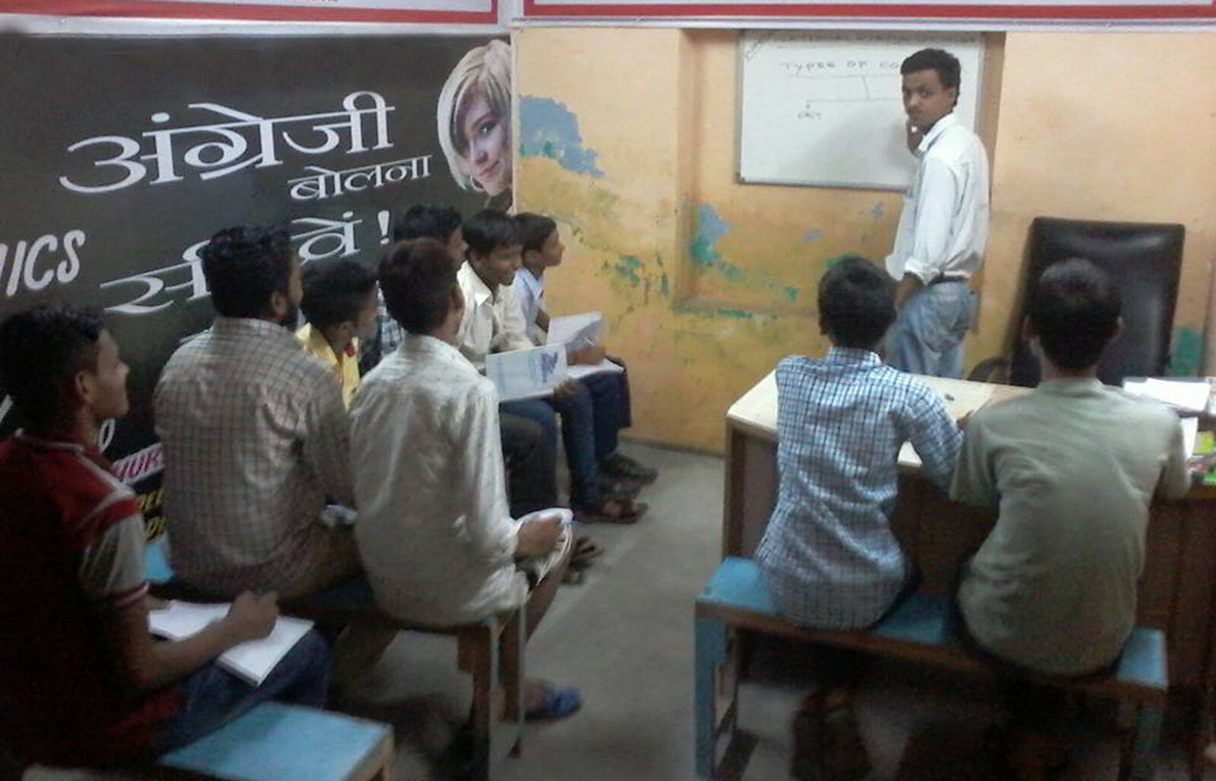 Man with short hair and hoodie smiling gently